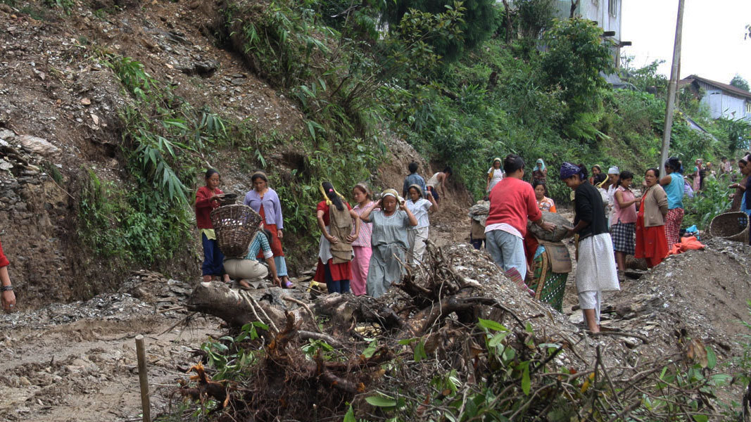 Community clearing debris after a landslide during a FOSEP disaster response
